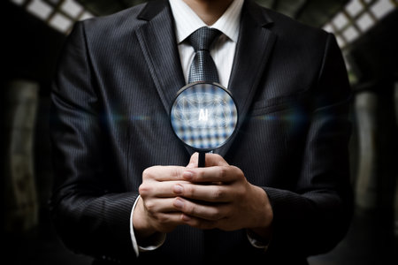 A well-dressed individual with a suit is examining a symbol representing artificial intelligence through a magnifying glass.の写真素材