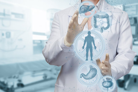 A healthcare worker in a lab coat uses advanced technology to engage with virtual representations of human organs. This is set in a modern medical facility with various tools visible.の写真素材