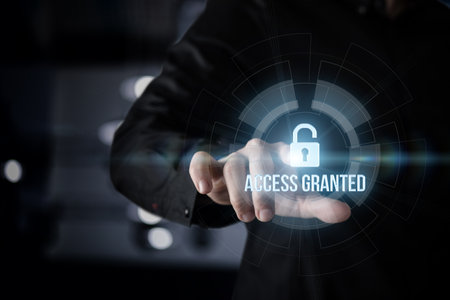 A person activates a digital interface by touching a holographic lock symbol, indicating successful access to a secure system. The environment is dark with glowing screens.の写真素材