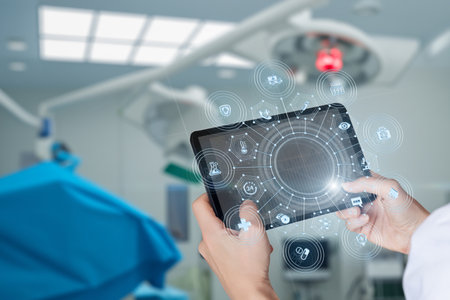A medical professional interacts with a tablet displaying digital icons in an operating room, enhancing surgical efficiency and patient care. The environment is modern and high-tech.の写真素材