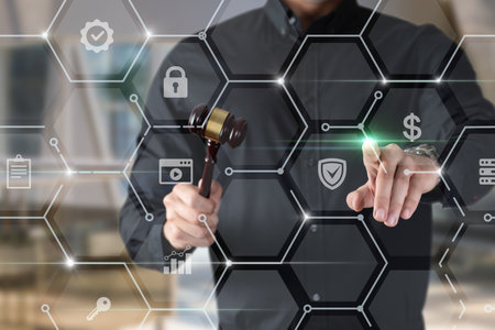 A person in a black shirt holds a gavel while interacting with digital security icons. This moment reflects the merging of law and technology in modern legal frameworks.の写真素材