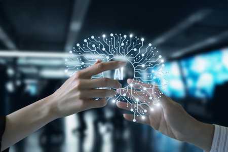 Two hands reach towards a glowing symbol of artificial intelligence, surrounded by intricate digital circuits in a modern technology environment. The setting suggests innovation and collaboration.の写真素材