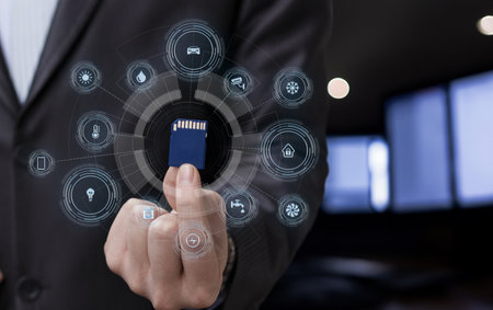 A businessman in a suit holds a memory card in one hand while digital icons representing various...