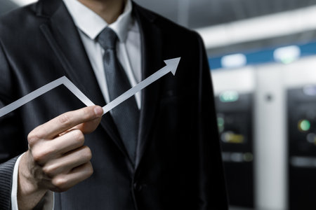 A professional in a suit holds an upward trend line to signify growth and success in financial...