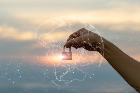 Securing the future with digital protection and connection. Hand holds a padlock against a glowing...