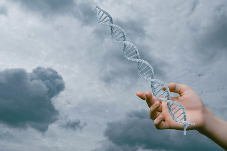 Hand holding DNA strand against a dramatic sky backdrop. A hand grasps a spiral DNA model as dark clouds loom overhead evoking thoughts on genetics.の写真素材