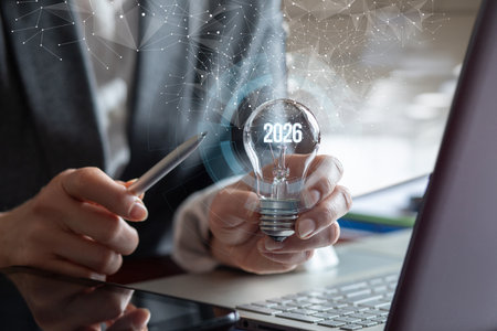 Planning for the future through innovative ideas and technology. A person holds a light bulb with...