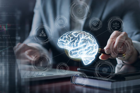 Tech sparks creativity. A person interacts with a glowing brain graphic while working at a laptop.