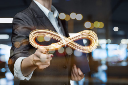 A business person skillfully draws light trails in a modern workspace, captivating all.の写真素材