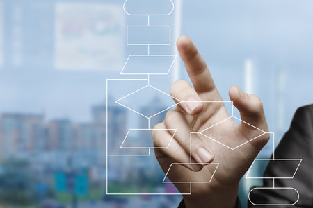 A business person uses a digital interface while planning strategic steps for success.