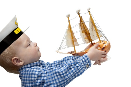 Portrait of the cute child  with the model ship