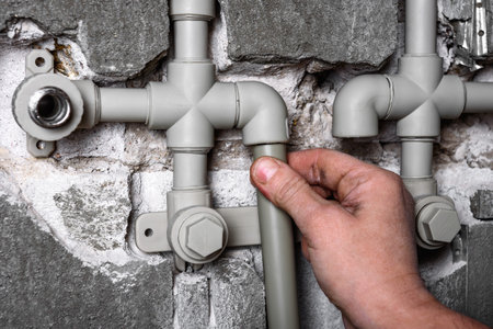 Installation of new polypropylene plumbing pipes in the wall.の写真素材