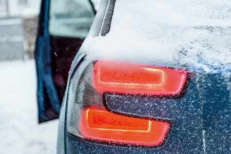 Close-up of rear light of car in winter.の写真素材