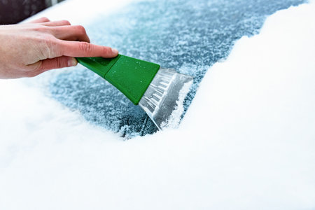 Clearing and remove snow from car windshield.の写真素材