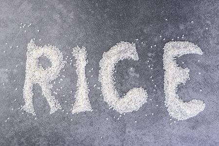 Rice in form of words on gray background.