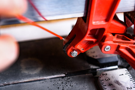 Spraying cutting roller in tile cutter.