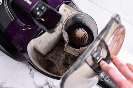 Vacuum cleaner full of garbage after home cleaning.
