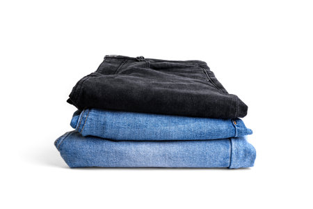 Stack of woman's jeans isolated on white background.の写真素材