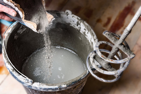 Mixing glue with mixer drill at the construction site.の写真素材