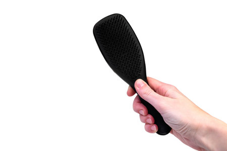 Black hair plastic comb isolated on white background.の写真素材