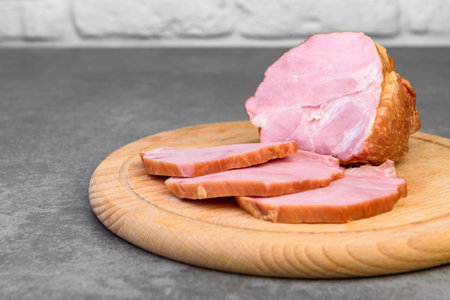 Sliced cold smoked meat on gray background.の写真素材