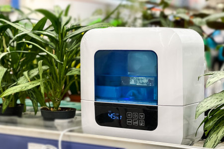 Modern air humidifier for indoor plants. Steam vaporizer standing near greenhouse plants.の写真素材