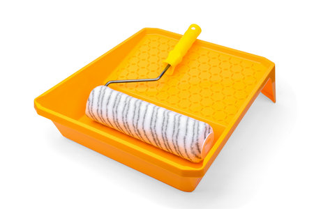 Yellow roller tray and roller isolated on white background.の写真素材