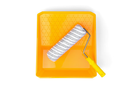 Yellow roller tray and roller isolated on white background.の写真素材