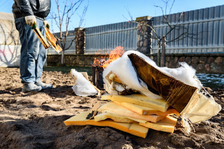Man burning old sofa in bonfire in early spring.の写真素材