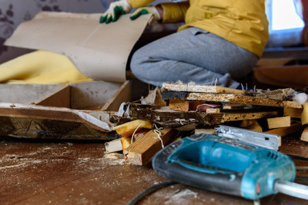 Getting rid of old things. Disassembling an old sofa in the attic.の写真素材
