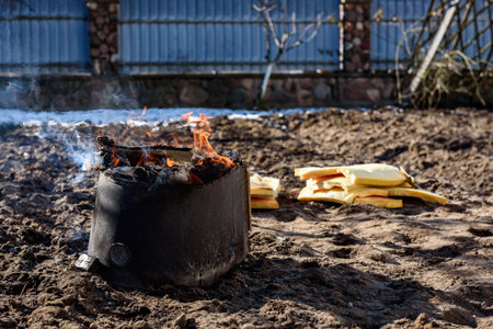 A man burning old unwanted things from home in a bonfire in early spring.の写真素材