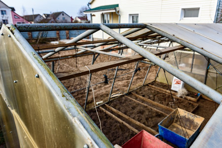 Repair of an old greenhouse on a spring day, greenhouse renovation.の写真素材