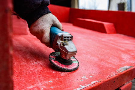 Rebuilding upgrading and modifying trailer. Man grinding old paint from trailer.の写真素材