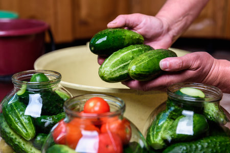 Preservation of seasonal vegetables. Washing cucumbers before the preparation of canned food, the...