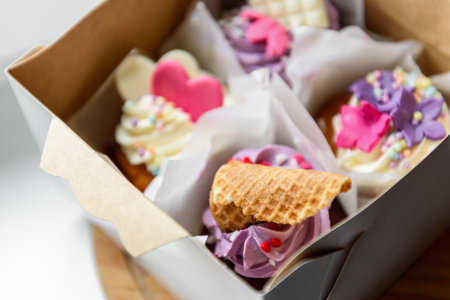 Cupcakes with cream and sprinkles isolated on white backgroundの写真素材