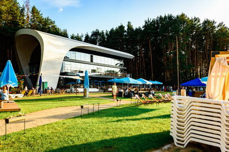 People at a sunny terrace with umbrellas at a restaurant near the seaの写真素材
