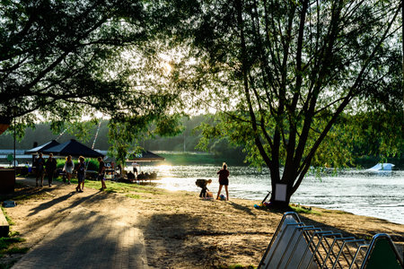 People at a sunny outdoor area with umbrellas near the seaの写真素材