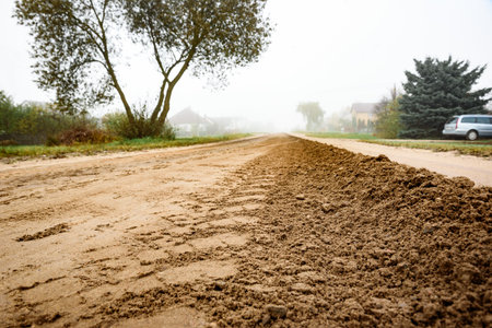 Grading of a dirt road in late autumnの写真素材