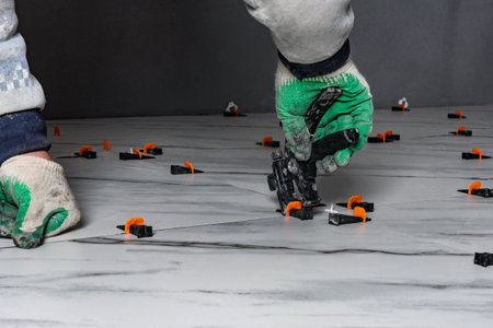 Installation of the tile laying system (wedges) using tongsの写真素材