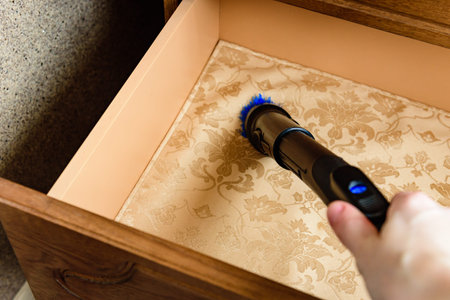 Vacuuming an empty drawer in the dressing room