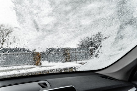 Thawing of car glass from the interior in winterの写真素材