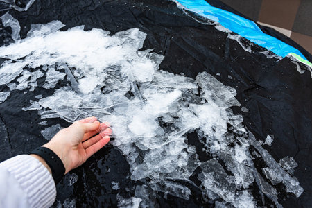 Car is protected from weather by tarpaulin cover in winter.