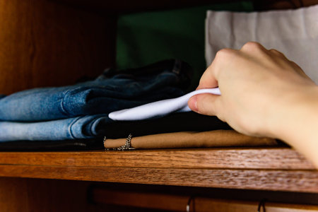 Organization and storage of things on the shelves of the wardrobe in the dressing room.