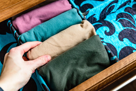 Organization and storage of T-shirts in a chest of drawersの写真素材