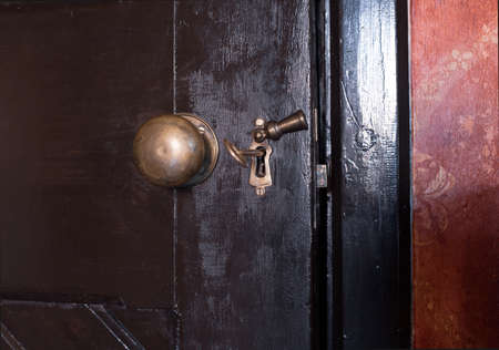 Old wooden door with lock and the key.の写真素材