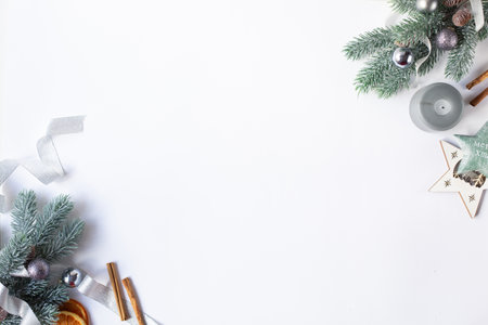 Christmas decorations, candles and fir branches and orange slices are on a white background. Free space for text.の写真素材