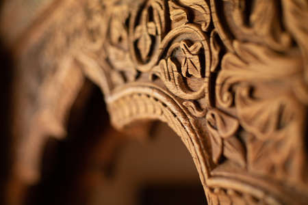 Fragment of an arch made of wood with carvings in the form of an ornament in the Indian style.の写真素材
