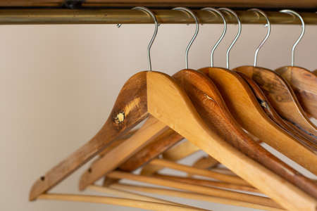 Rack with wooden clothes hangers on a white background. Retro style.の写真素材