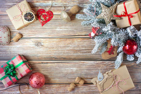 Christmas decorations, gifts and christmas balls are on wooden background. Background on the New Year theme in the form of a frame. Free space for text in the center. View from the top point.の写真素材