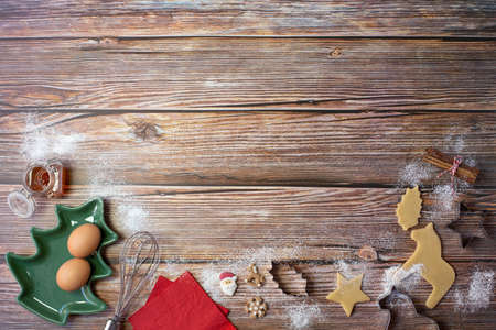 Baking figures cut out of dough, bakeware, eggs and other kitchen items for baking Christmas cookies...